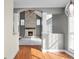 Spacious living room with a stone fireplace, hardwood floors, and white pillars at 7845 W Hillside Dr, Columbus, IN 47201