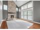 Living room with stone fireplace, hardwood floors and lots of natural light at 7845 W Hillside Dr, Columbus, IN 47201