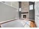 Open living room with a soaring ceiling, stone fireplace, hardwood floors and a white accent rug at 7845 W Hillside Dr, Columbus, IN 47201