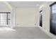 Neutral living room with carpeted floors, ample natural light, and decorative columns at 7845 W Hillside Dr, Columbus, IN 47201