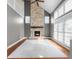 Bright living room features a stone fireplace, hardwood floors and large windows that let in natural light at 7845 W Hillside Dr, Columbus, IN 47201