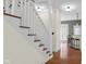 Close-up of staircase leading to the second story, adjacent to the open-concept kitchen at 7845 W Hillside Dr, Columbus, IN 47201