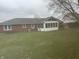 Expansive backyard with a sunroom addition to the brick home at 805 Stewart Rd, Anderson, IN 46012
