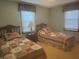 Bedroom featuring two twin beds with quilt bedding and wooden headboards with a small side table at 805 Stewart Rd, Anderson, IN 46012