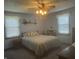 Cozy bedroom with a ceiling fan, natural lighting, and comfortable bedding at 805 Stewart Rd, Anderson, IN 46012