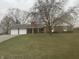 Charming brick home with attached two car garage and spacious front yard at 805 Stewart Rd, Anderson, IN 46012