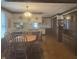 Open concept kitchen and dining area with wooden cabinetry, dining table, and hardwood floors at 805 Stewart Rd, Anderson, IN 46012