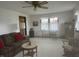 Bright living room featuring neutral carpet, ceiling fan, and natural lighting at 805 Stewart Rd, Anderson, IN 46012