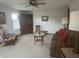 Comfortable living room featuring neutral carpet, ceiling fan, and large furniture set at 805 Stewart Rd, Anderson, IN 46012