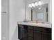 Bathroom featuring dual sinks, dark cabinets, a large mirror, and modern lighting at 8153 Fivespot Ln, Plainfield, IN 46168