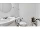 Bathroom features white fixtures, round mirror, and neutral wall color at 8153 Fivespot Ln, Plainfield, IN 46168
