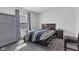 Bedroom boasts natural light, gray carpet, and a comfortable bed next to a dark wood nightstand at 8153 Fivespot Ln, Plainfield, IN 46168