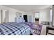 Bright bedroom is furnished with patterned rug, mirrored dresser, and view to the living room at 8153 Fivespot Ln, Plainfield, IN 46168