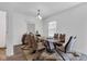 Dining room showcases modern furniture, chandelier lighting and layered window shades at 8153 Fivespot Ln, Plainfield, IN 46168