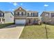 Inviting two-story home with a well-manicured lawn and attached two-car garage at 8153 Fivespot Ln, Plainfield, IN 46168