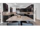 Stylish kitchen featuring dark wood cabinets, stainless steel appliances and mosaic backsplash at 8153 Fivespot Ln, Plainfield, IN 46168