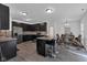 Modern kitchen with sleek cabinetry, an island with stools, and an adjacent dining area at 8153 Fivespot Ln, Plainfield, IN 46168