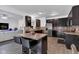Well-appointed kitchen with dark cabinetry, center island with barstools, and open layout at 8153 Fivespot Ln, Plainfield, IN 46168