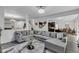 Open living room with a large sectional sofa, contemporary rug and chandelier at 8153 Fivespot Ln, Plainfield, IN 46168