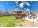 Expansive backyard featuring a wooden deck and a concrete patio seating area at 868 Glendale Dr, Franklin, IN 46131