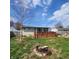 A spacious backyard features a wooden deck, lush lawn, and firepit perfect for outdoor gatherings and relaxation at 868 Glendale Dr, Franklin, IN 46131