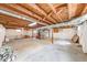 Unfinished basement with exposed wood beams, painted walls, and concrete floor at 868 Glendale Dr, Franklin, IN 46131
