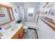 Full bathroom with wood-look flooring, tile surround, and a wooden vanity at 868 Glendale Dr, Franklin, IN 46131