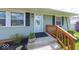Inviting front porch with a decorative flower pot, dark shutters, and updated door at 868 Glendale Dr, Franklin, IN 46131