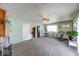 Spacious living room with a rocking chair and neutral carpet and an exterior door at 868 Glendale Dr, Franklin, IN 46131