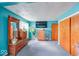 Main bedroom with turquoise walls, wooden dressers and a flat screen TV at 868 Glendale Dr, Franklin, IN 46131