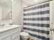 Bathroom featuring a white vanity, toilet, and a blue and white striped shower curtain at 887 Tuxedo Dr, Westfield, IN 46074