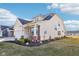 Charming two-story home with a well-manicured lawn and landscaping, featuring a cozy front porch at 887 Tuxedo Dr, Westfield, IN 46074