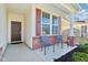 Inviting front porch with red brick accents, and two chairs perfect for relaxing at 887 Tuxedo Dr, Westfield, IN 46074