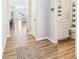Hallway with wood floors provides views to the living room and nearby bathroom at 887 Tuxedo Dr, Westfield, IN 46074