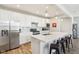 Bright kitchen with stainless steel appliances, white cabinetry, and an island with a sink at 887 Tuxedo Dr, Westfield, IN 46074