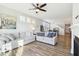 Open-concept living room with wood floors, fireplace, and plenty of natural light at 887 Tuxedo Dr, Westfield, IN 46074