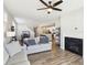 Cozy living room with hardwood floors, modern fireplace, and adjacent dining area at 887 Tuxedo Dr, Westfield, IN 46074