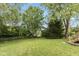 Large backyard featuring well-maintained lawn and mature trees, providing a serene outdoor space at 9462 Bent Brook Dr, Indianapolis, IN 46250