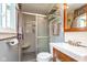 This bathroom is well-appointed with a shower, frosted glass door, modern fixtures, and practical shelving at 9462 Bent Brook Dr, Indianapolis, IN 46250