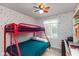 A colorful bedroom featuring a bunk bed, cheerful decor, and a window with plenty of natural light at 9462 Bent Brook Dr, Indianapolis, IN 46250