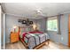 A cozy bedroom featuring a decorative quilt, ceiling fan, and natural light from the window at 9462 Bent Brook Dr, Indianapolis, IN 46250