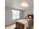 Comfortable bedroom with warm wood furniture, neutral walls, and a sunny window that enhances the space at 9462 Bent Brook Dr, Indianapolis, IN 46250