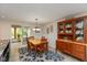 Cozy dining room featuring a wooden table, a china cabinet, and natural lighting at 9462 Bent Brook Dr, Indianapolis, IN 46250