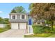 Charming gray split-level home with a blue front door and a two-car garage at 9462 Bent Brook Dr, Indianapolis, IN 46250