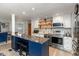 Modern kitchen featuring stainless steel appliances, white cabinets, and a blue island at 9462 Bent Brook Dr, Indianapolis, IN 46250