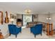 Bright living room featuring two velvet armchairs, a cozy sofa, and a large window at 9462 Bent Brook Dr, Indianapolis, IN 46250