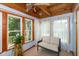 Bright sunroom with wood ceiling and beams offers a peaceful retreat with lots of natural light at 9462 Bent Brook Dr, Indianapolis, IN 46250
