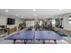 Spacious basement features a ping pong table, TV, and home gym area at 97 N Maple St, Pittsboro, IN 46167