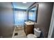 Traditional bathroom featuring a wooden vanity, neutral countertops, and a shower-tub combo at 97 N Maple St, Pittsboro, IN 46167