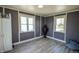 Bedroom with stylish floors, neutral walls, and natural light from two windows at 97 N Maple St, Pittsboro, IN 46167